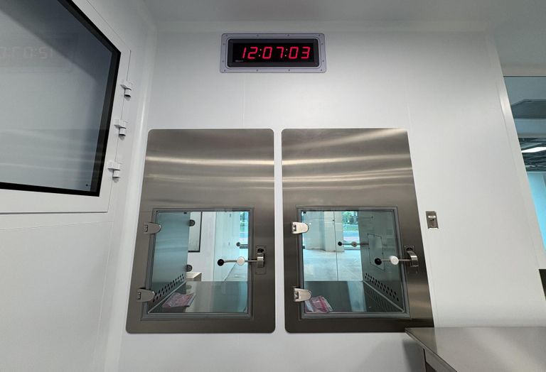 Two material pass through boxes in one of the AstraZeneca facility's closed processing rooms.