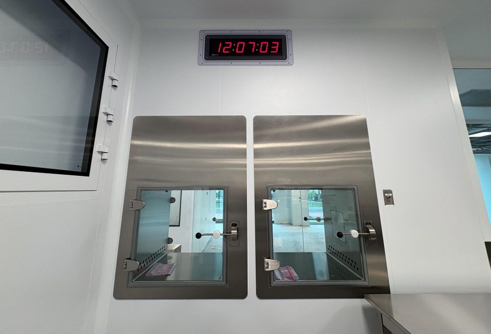 Two material pass through boxes in one of the AstraZeneca facility's closed processing rooms.