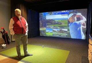 RXR's head of leasing, Bill Elder, on the green at 5 Times Square's golf simulator.