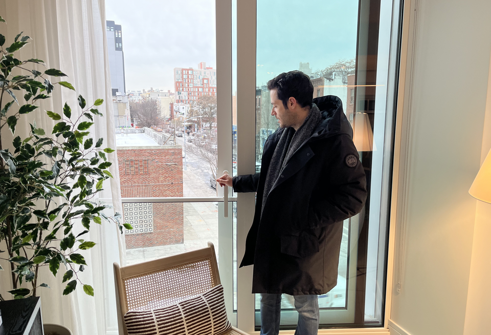 Charney Cos.' Pelsinger demonstrates the sliding window in residential units at Union Channel.
