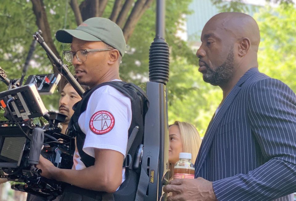 Yoba with a cameraperson on the set of 'The Real Estate Mix Tape.'