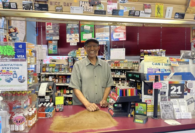 A photograph of Yohannes Hailleab, owner of Sooper B Liquors on South Broadway