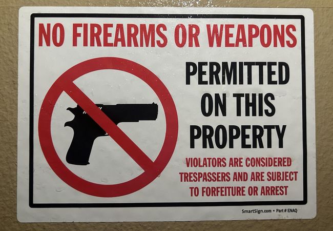 No Firearms Or Weapons Permitted on this property sign