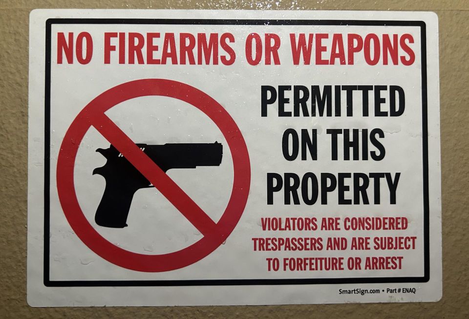 No Firearms Or Weapons Permitted on this property sign