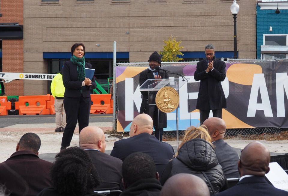 Mayor Muriel Bowser (left) and Council Members Trayon White Sr. (center) and Kenyan McDuffie (right) applaud developers during a groundbreaking for Phase 2 of the MLK Gateway development.