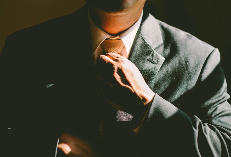 Man adjusting tie suit businessman