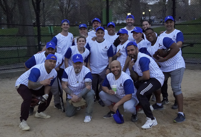 Jamil Lacourt and a group from L&L playing softball. 
