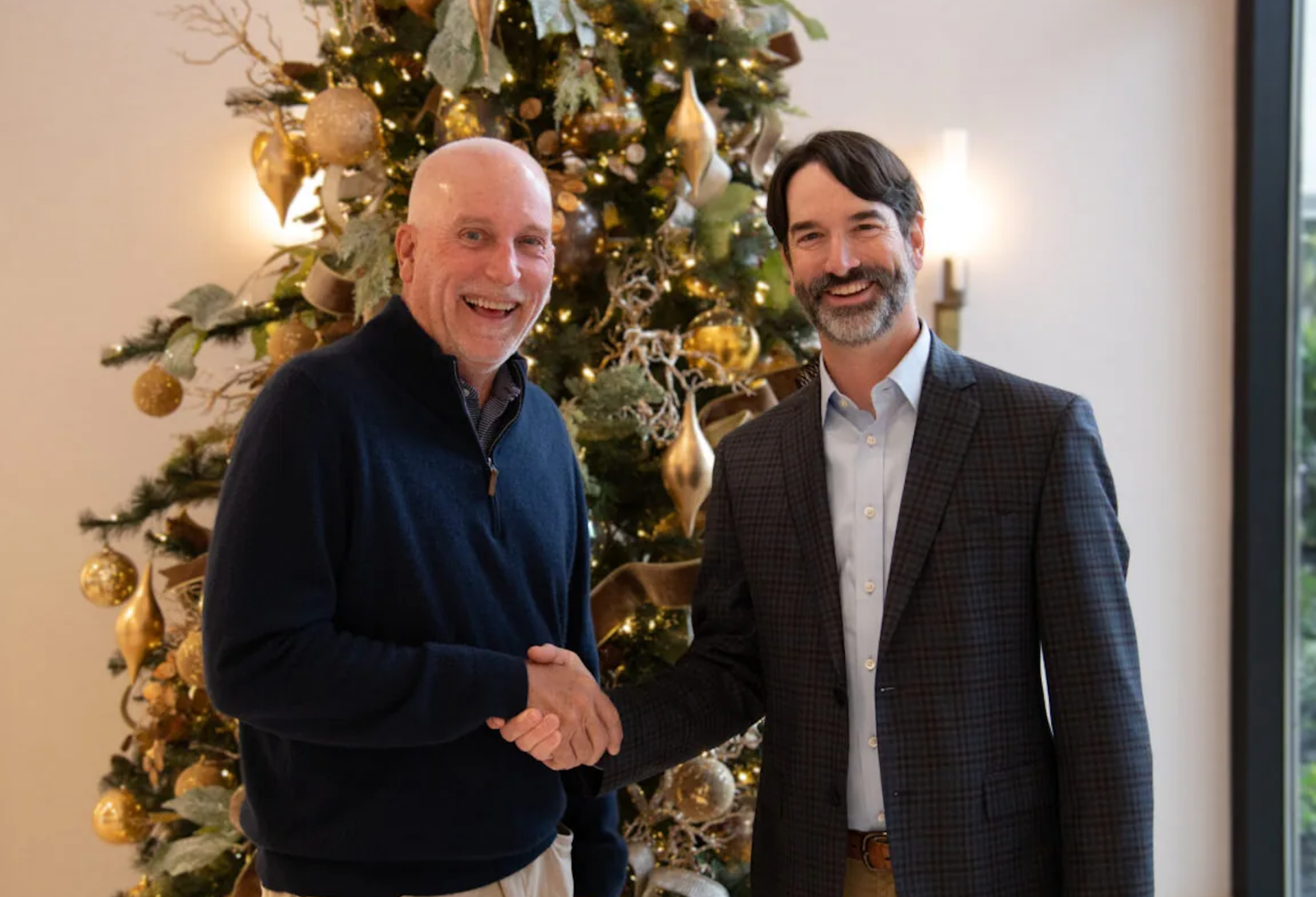 Lee & Associates' Wade Bowlin and Chris Lewis shaking hands.