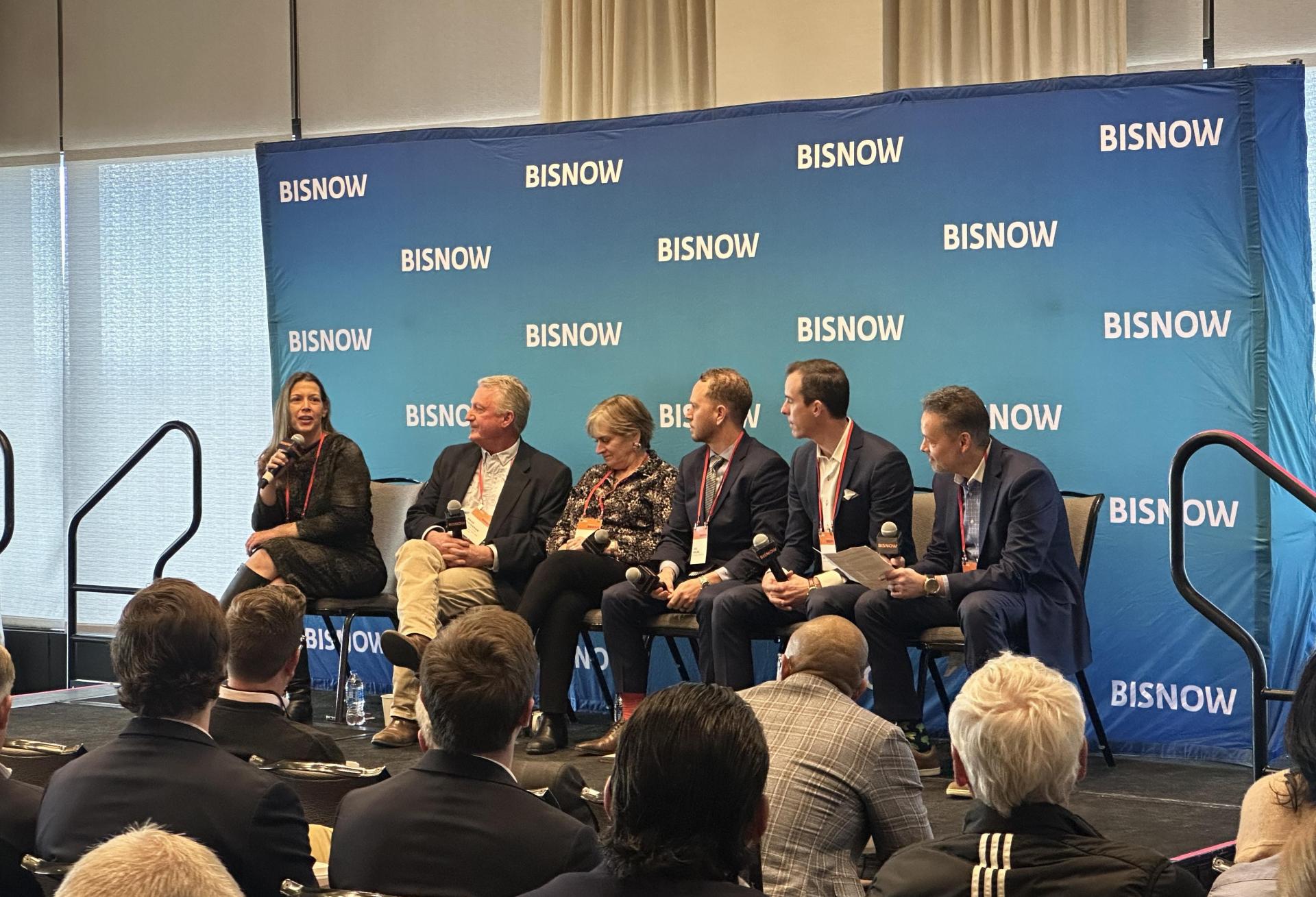 A panel sits on stage and discusses the state of commercial real estate in Denver in 2026.