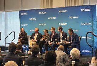 A panel sits on stage and discusses the state of commercial real estate in Denver in 2026.