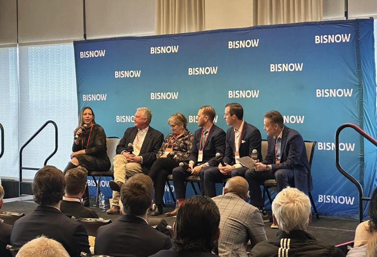 A panel sits on stage and discusses the state of commercial real estate in Denver in 2026.