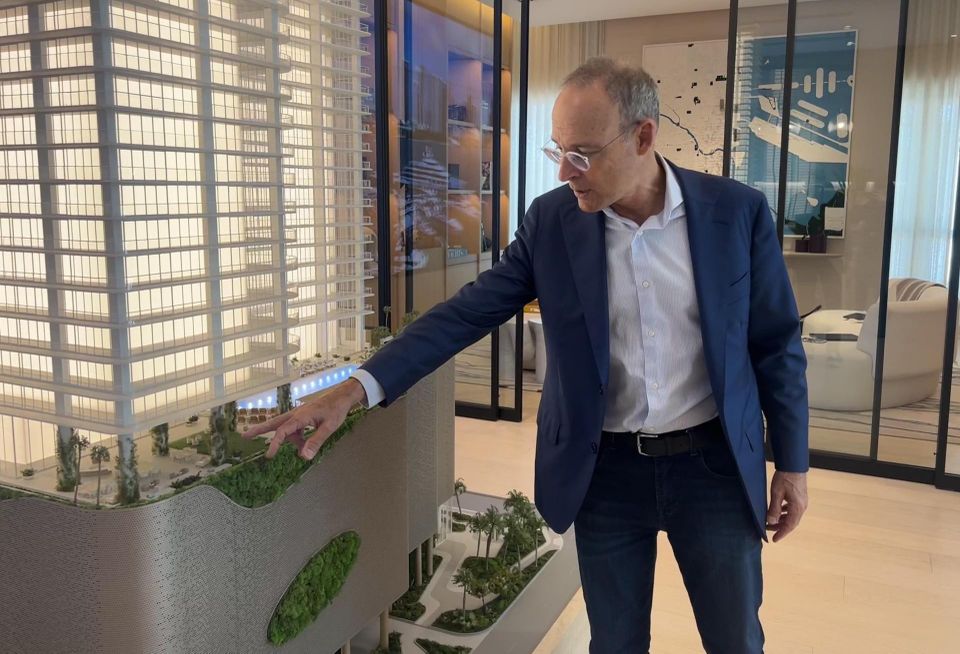 Miki Naftali pointing at the display for his JEM Residences