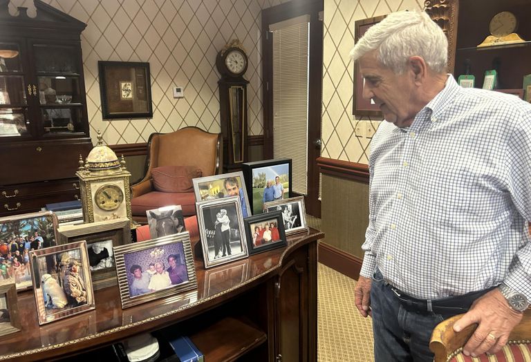 Ed Easton Looking at pictures of his family in his office