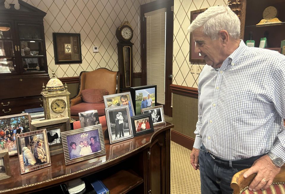 Ed Easton Looking at pictures of his family in his office