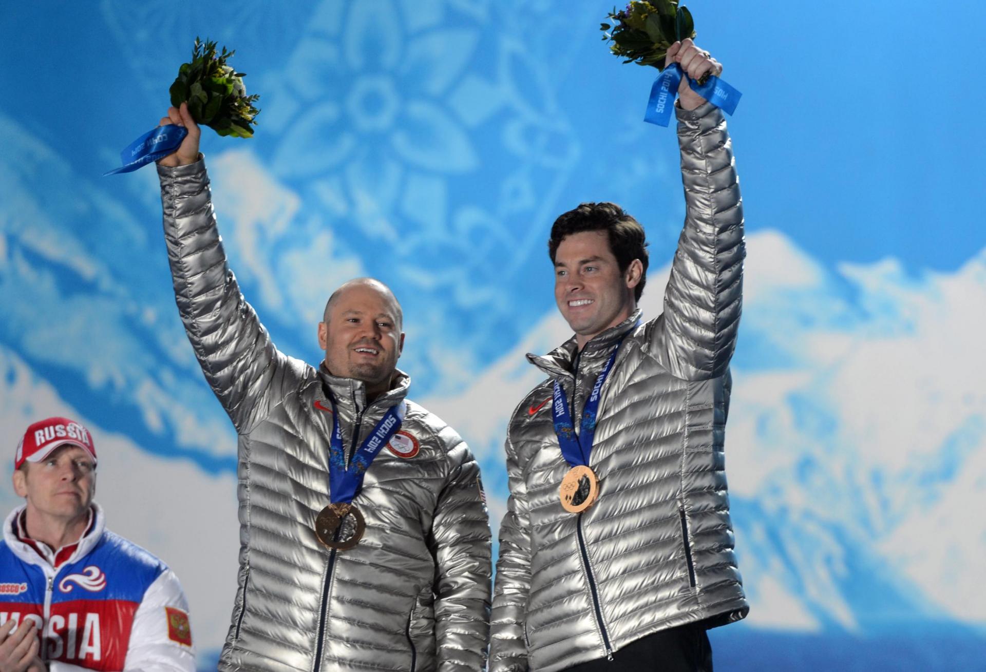 Steven Langton (right) and Steven Holcomb (left) displaying bronze medals in the 2014 Sochi Olympics. The two later had their medals upgraded to silver in 2019.