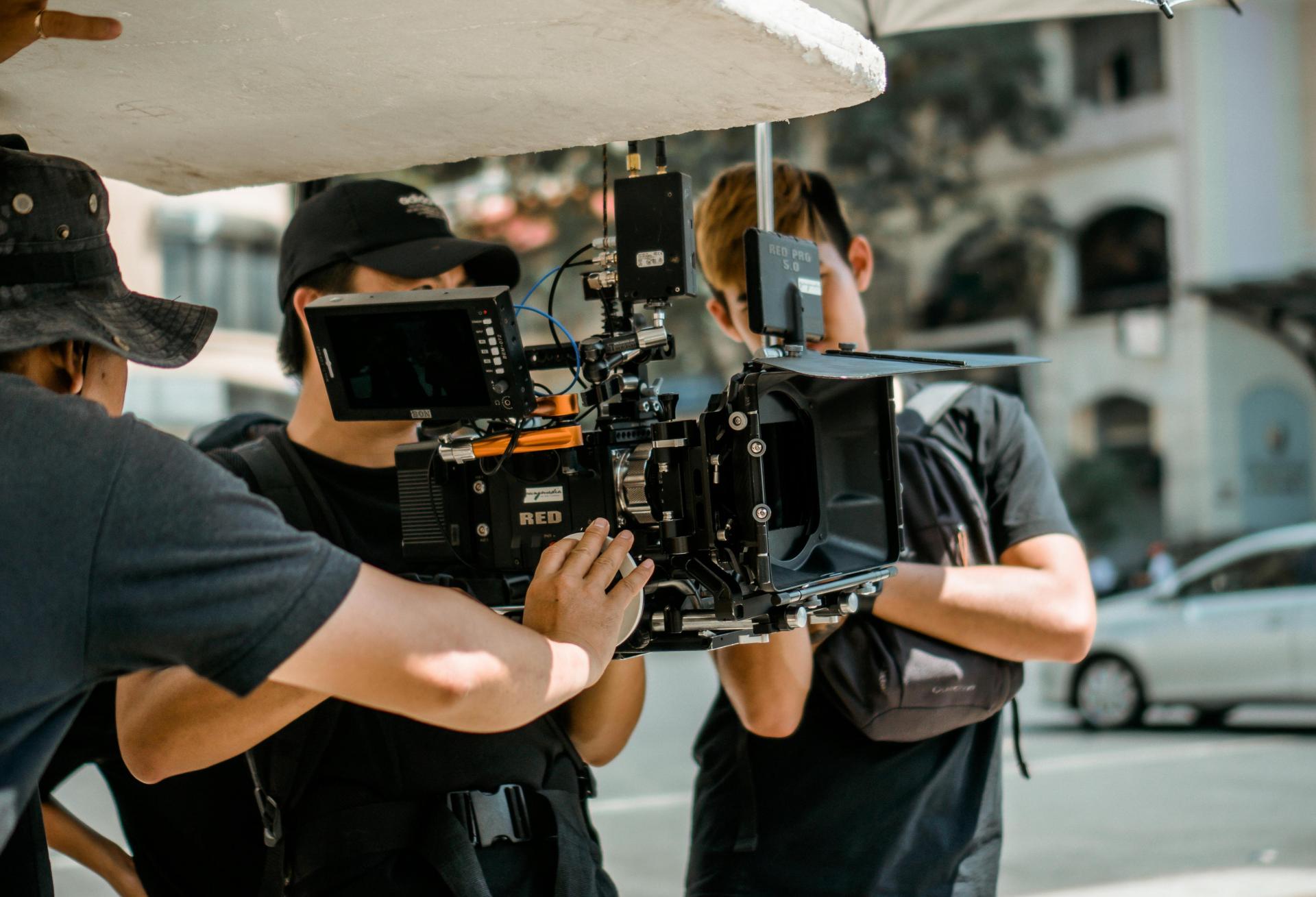 People holding a film camera. 