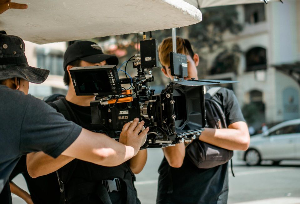 People holding a film camera.