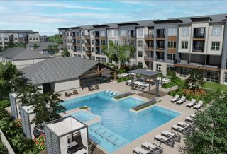 A rendering of the proposed Stack at Wheat Ridge multifamily community with the swimming pool featured prominently surrounded by multicolored apartment buildings.