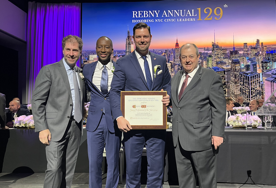 Cushman & Wakefield's Craig Waggner being presented REBNY's Young Real Estate Professional of the Year Award by Young Men’s/Women’s Real Estate Association of New York Chairman Sayo Kamara, alongside Two Trees' Jed Walentas and REBNY President Jim Whelan.