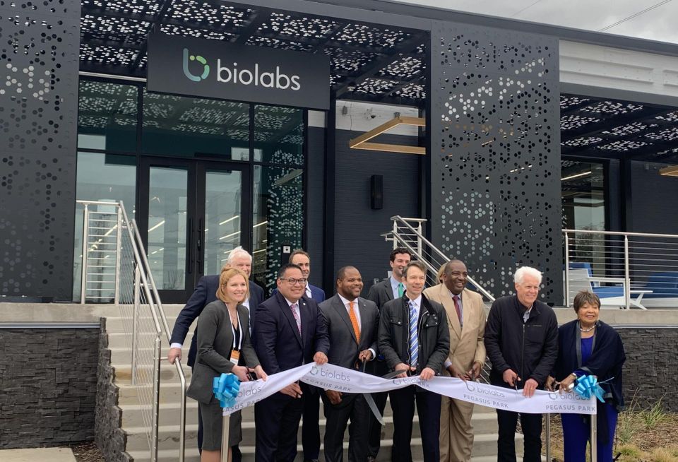 people cutting a ribbon