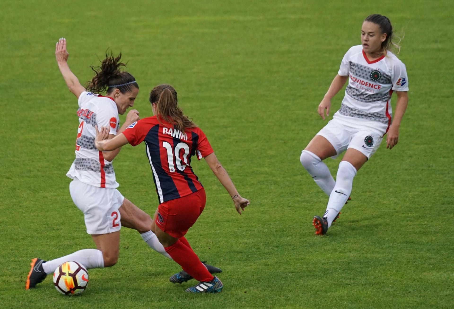 Three women play professional soccer for the National Women's Soccer League in a game of the Washington Spirit versus Portland Thorns.