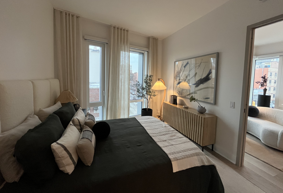 The bedroom and living room inside one of the units at Union Channel.