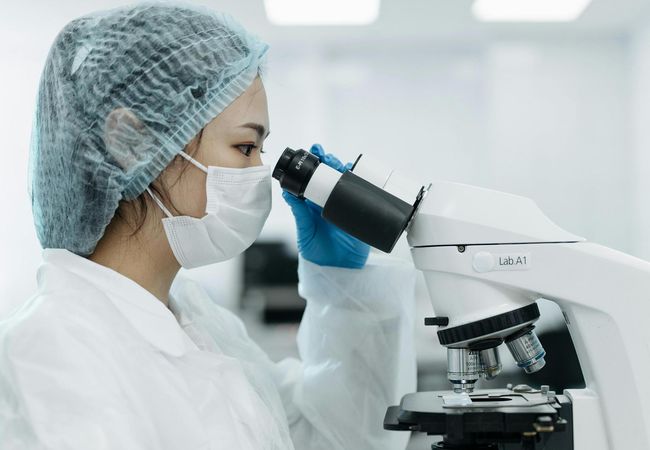 A person looking into a microscope