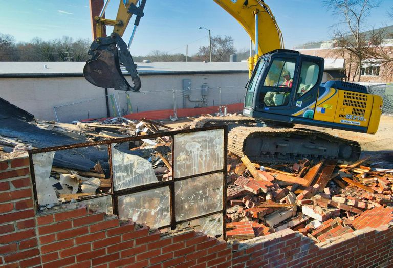 Demolition work on a brick building.