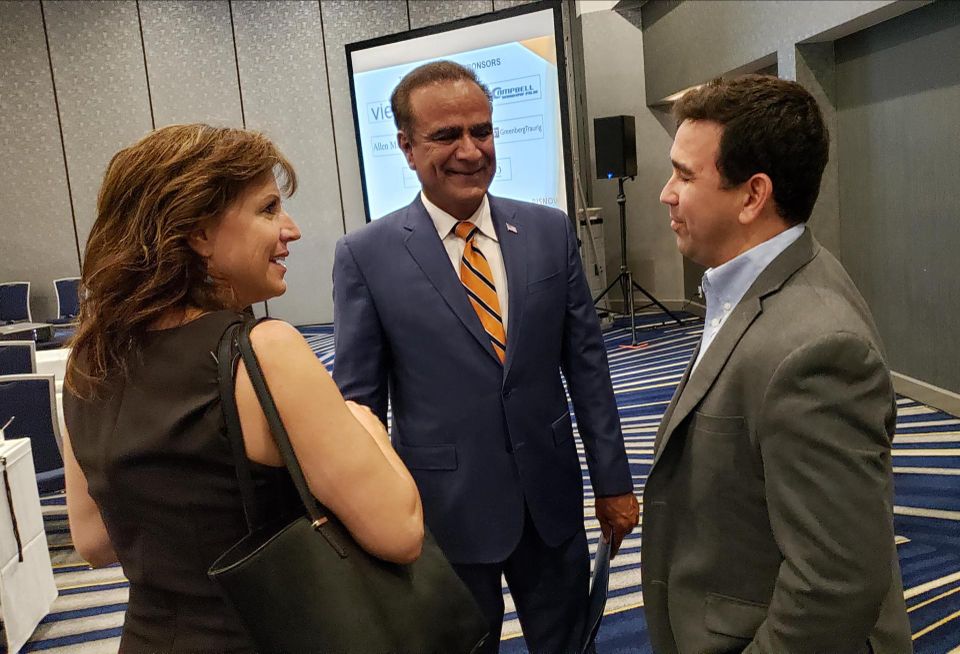 Mayor of Anaheim Harry Sidhu, center, talks to attendees at Bisnow's Orange County State of the Market event Wednesday at the Irvine Marriott.