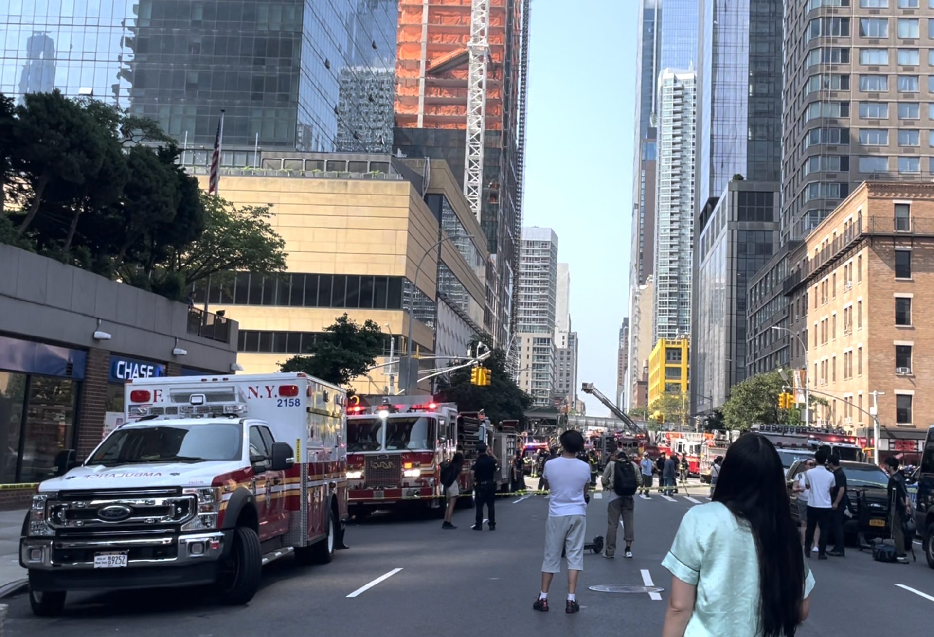 Bystanders And Emergency Personnel Look On After A Crane Partially Collapsed On 10Th Avenue In Manhattan July 26, 2023. Bystanders and emergency personnel look on after a crane partially collapsed on 10th Avenue in Manhattan July 26, 2023.