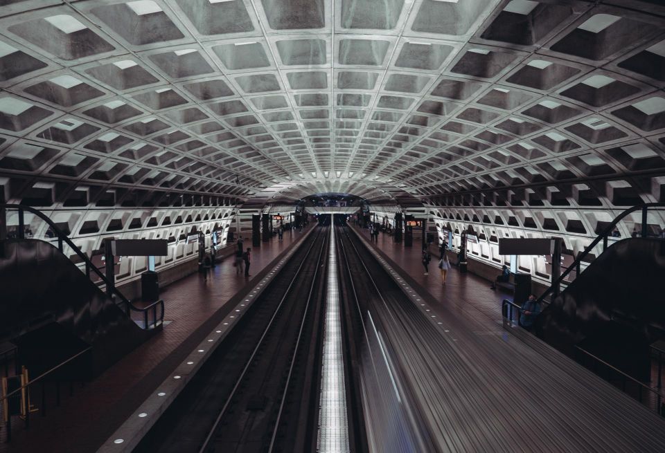 A Metro station with a few riders on each side of the platform