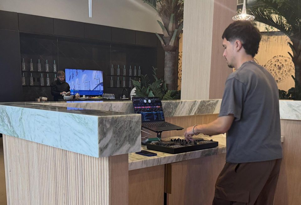 DJ playing music in sales gallery