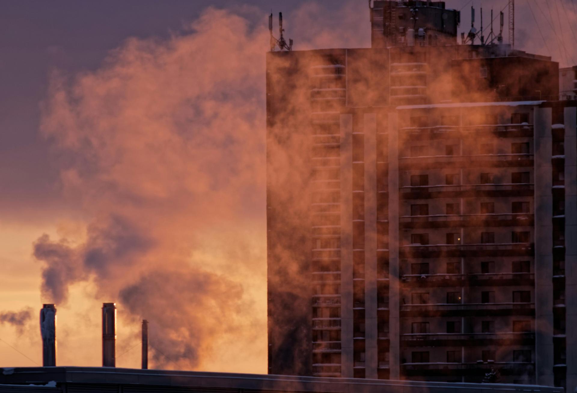 building emissions, carbon dioxide, greenhouse gas emissions, steam rising in front of an apartment building