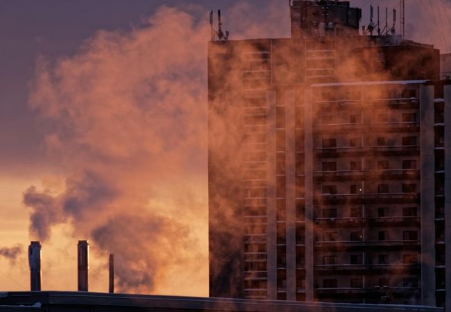 building emissions, carbon dioxide, greenhouse gas emissions, steam rising in front of an apartment building