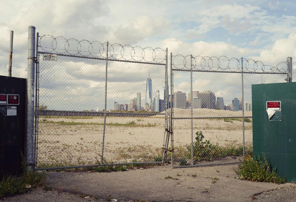 An empty lot with a view of Manhattan.
