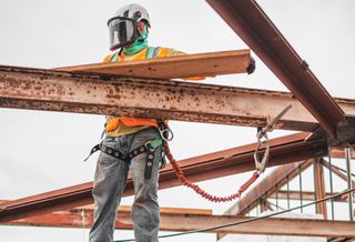Man constructing building.
