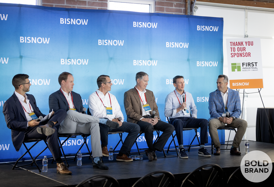 A high-resolution photograph of a panel at Bisnow's Denver industrial event