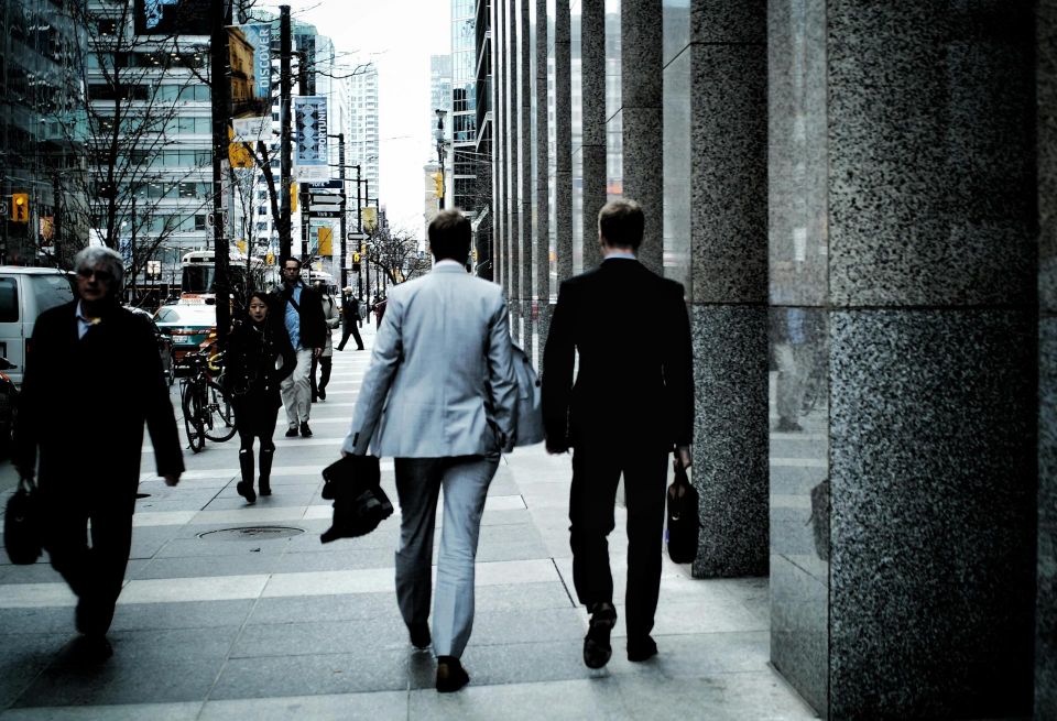Businessmen walking on a city street.