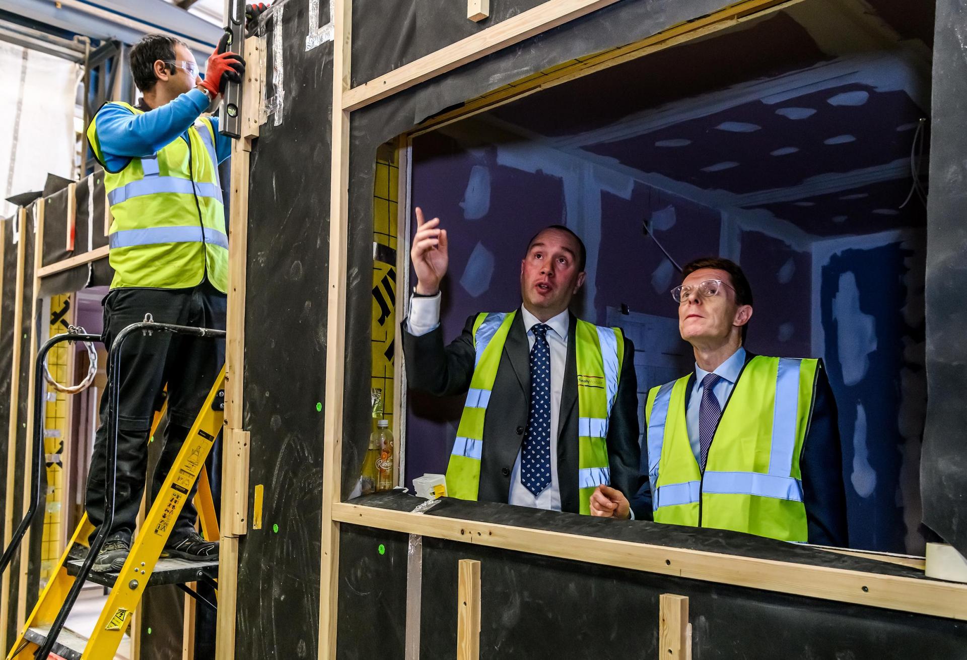 Operations Director At Totally Modular, Mick Pettitt (Second Left) Talking To Andy Street (Right) Inside One Of The Homes Which Are Being Built By Totally Modular. modular housing andy street