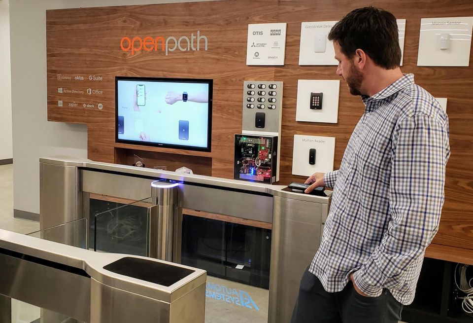 No more keycards. Openpath co-founder James Segil demonstrates how his phone allows him access through an automated entrance control gate.