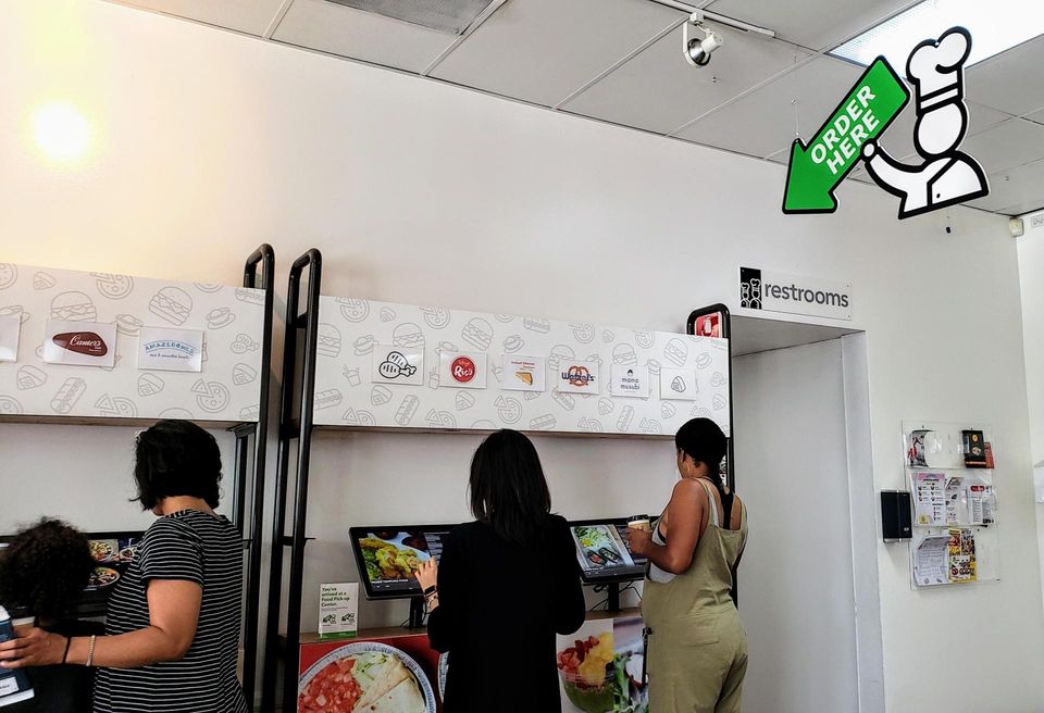 Visitors order inside Kitchen United's store, Eats on Madison, in Pasadena