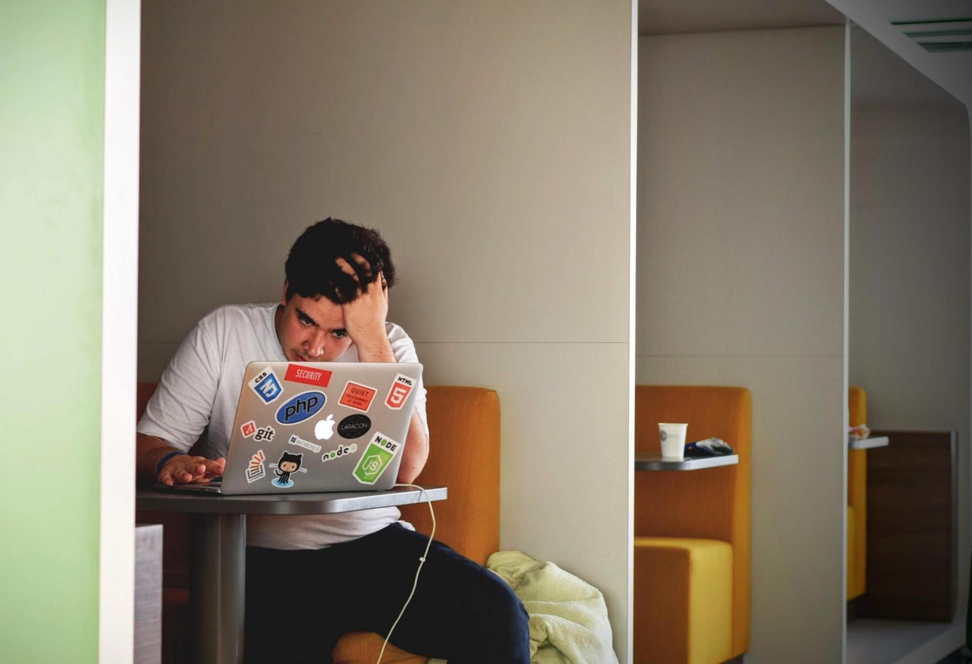 Frustrated remote worker sitting in front of laptop