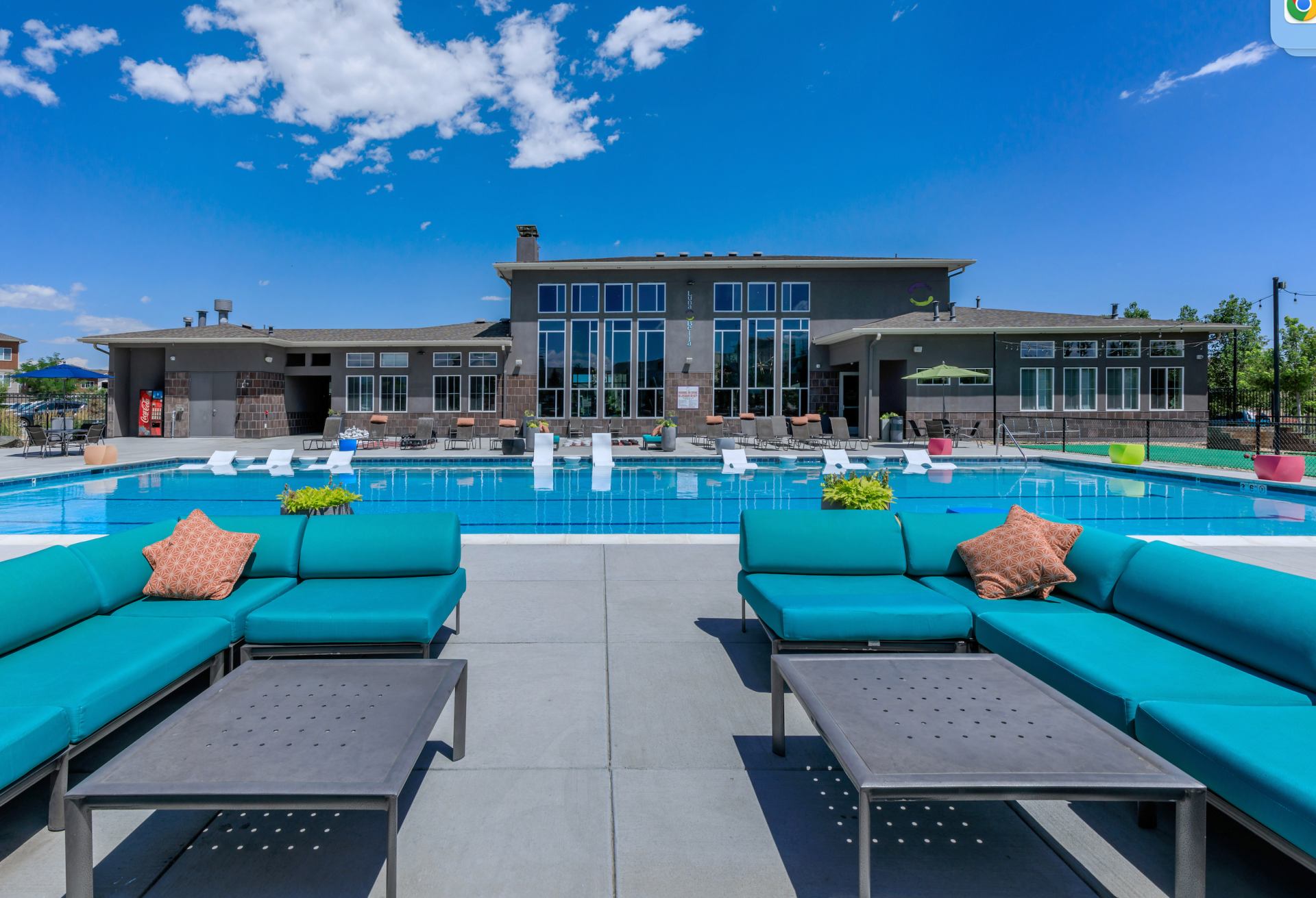 A high-resolution photo of the Bell Lafayette apartments from the perspective of a swimming pool in Lafayette, Colorado