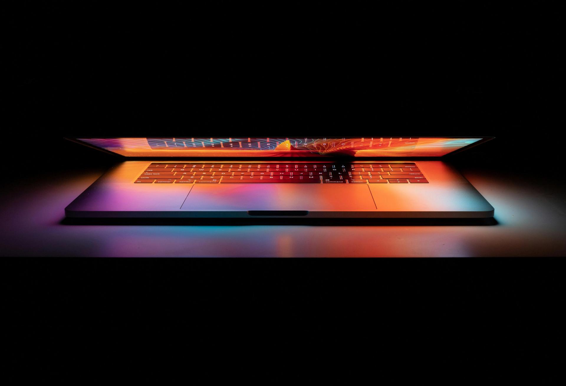 Half-closed computer on dark background