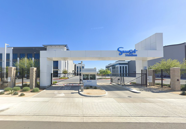 Entrance gate of Sunset Studios, featuring a white entrance arch.