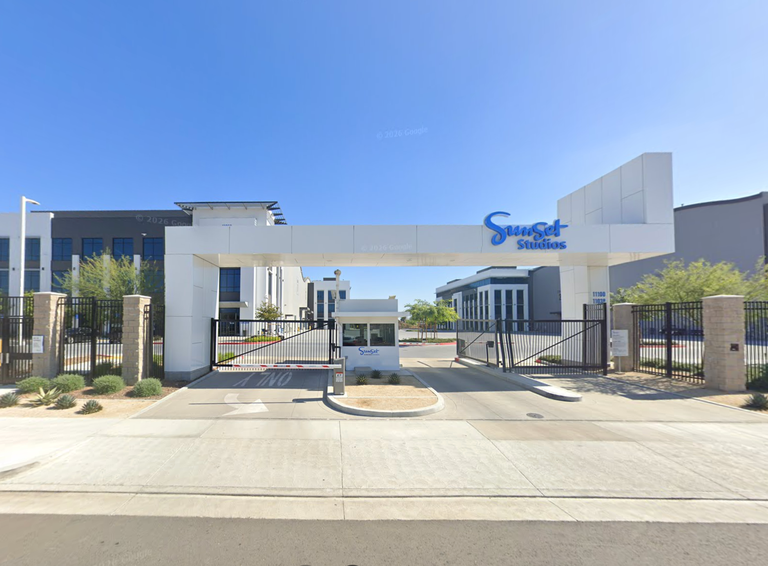 Entrance gate of Sunset Studios, featuring a white entrance arch.