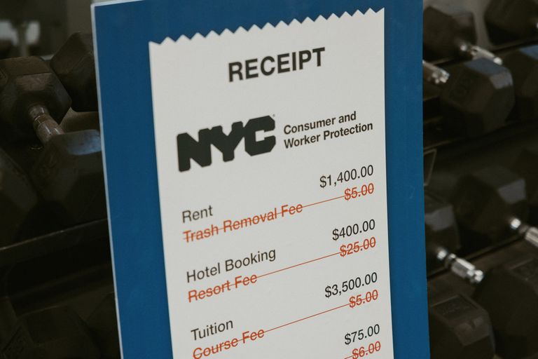 Receipt on a blue background with NYC Consumer and Worker Protection logo, listing amounts for rent, hotel booking, and tuition with crossed-out fees.