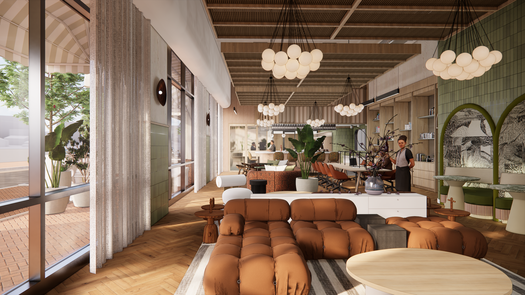 Stylish cafe interior with brown sofas, hanging globe lights, green decor, and large windows. A barista stands behind the counter.