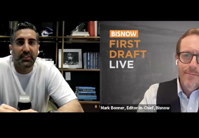 Two men in a virtual conference, one with books behind him, the other in front of a "BISNOW First Draft Live" sign.