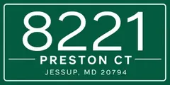 A green rectangular sign with white text: "8221 Preston Ct, Jessup, MD 20794."